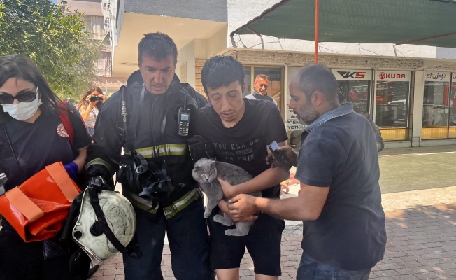  Alevlerin sardığı evde balkona sığındı, kedisini elinden bırakmadı