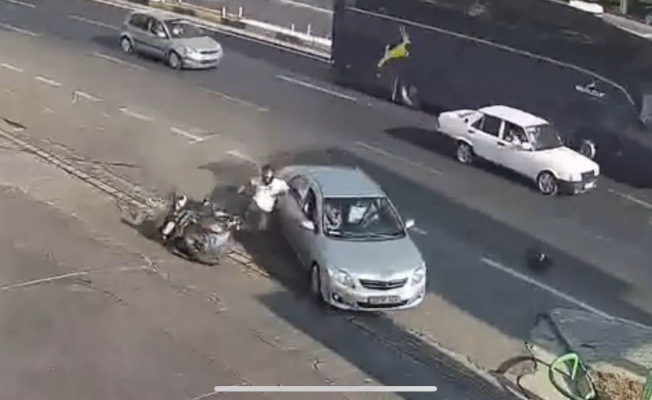Kazada motosiklet sürücüsü çarpıştığı otomobilin kapısına tutunup sonra yere düştü